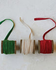 Soft velvet ribbon displayed on natural wood spool