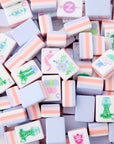 Luminaire Mahjong Tiles in coral and pink with periwinkle backing displayed on table