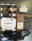 Halloween gift box with curated treats and seasonal decorations for parties.