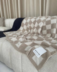 Cozy teddy fleece blanket with checkered pattern, ideal for holiday home decor