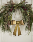 Aged brassy metal Bow Wreath with gold chain, decorative holiday bow for door or wreath display, vintage-inspired holiday décor.