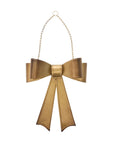 Aged brassy metal Bow Wreath with gold chain, decorative holiday bow for door or wreath display, vintage-inspired holiday décor.