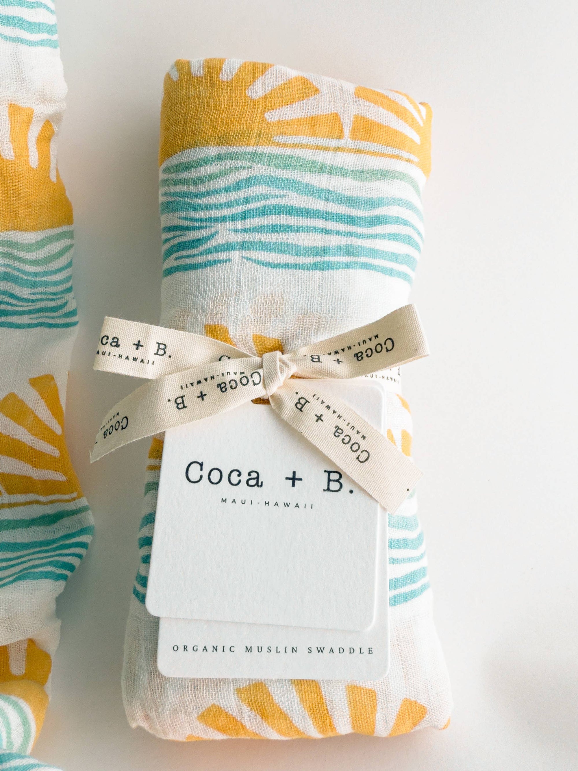 Sustainable bamboo and cotton baby swaddle with retro surfer-inspired design