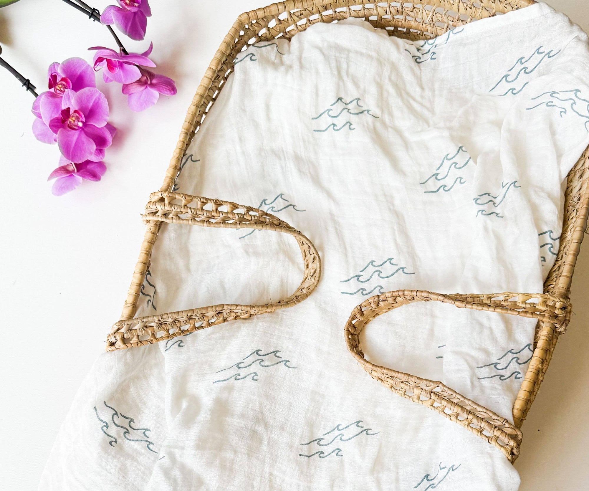 47-inch square Coastal Wave Swaddle Blanket in organic bamboo and cotton with hand-carved block print wave motif, gift-ready