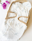 47-inch square Coastal Wave Swaddle Blanket in organic bamboo and cotton with hand-carved block print wave motif, gift-ready