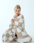 Soft checkered teddy blanket with plush texture, perfect for cozy winter nights