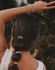 Stacked hair tie bracelets in earthy and soothing beach-inspired tones