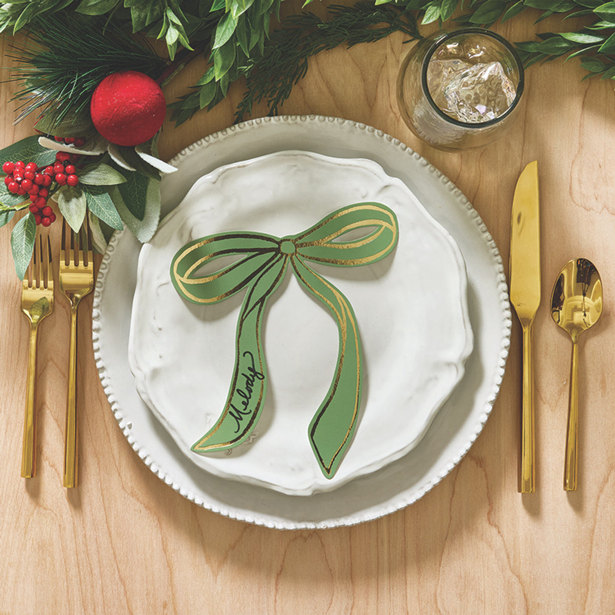 Holiday table placecards in moss green with metallic bow detail for dinners and events