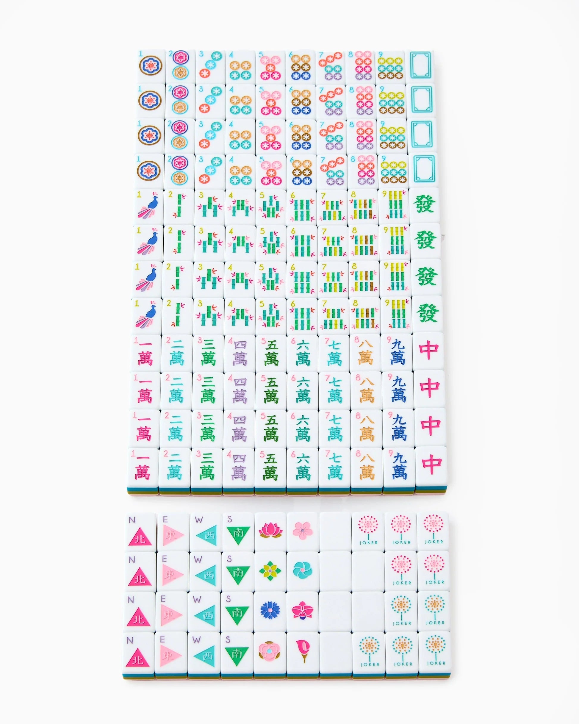 La Fête Mahjong Tiles in olive green, pink, and teal displayed on tabletop