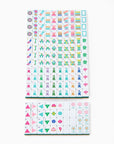 La Fête Mahjong Tiles in olive green, pink, and teal displayed on tabletop