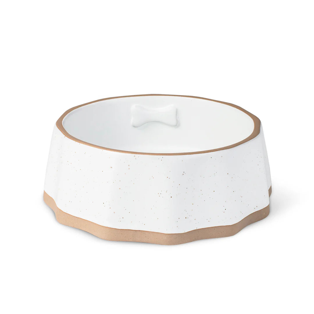Modern matte ivory stoneware dog bowl with raised bone icon and exposed edges, dishwasher and microwave safe, perfect for stylish pet homes.