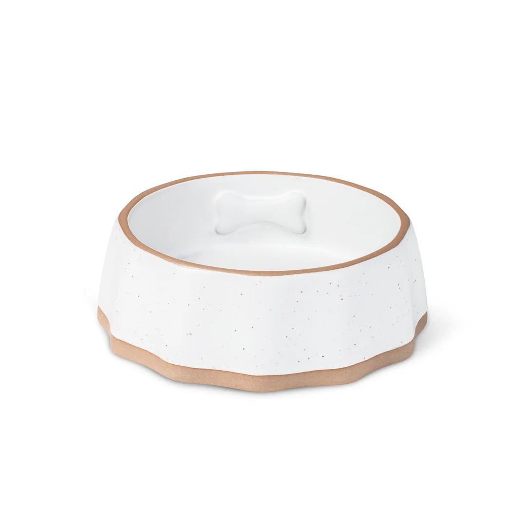 Small matte ivory stoneware dog bowl with raised bone icon and exposed edges, dishwasher and microwave safe, ideal for small dogs or cats.