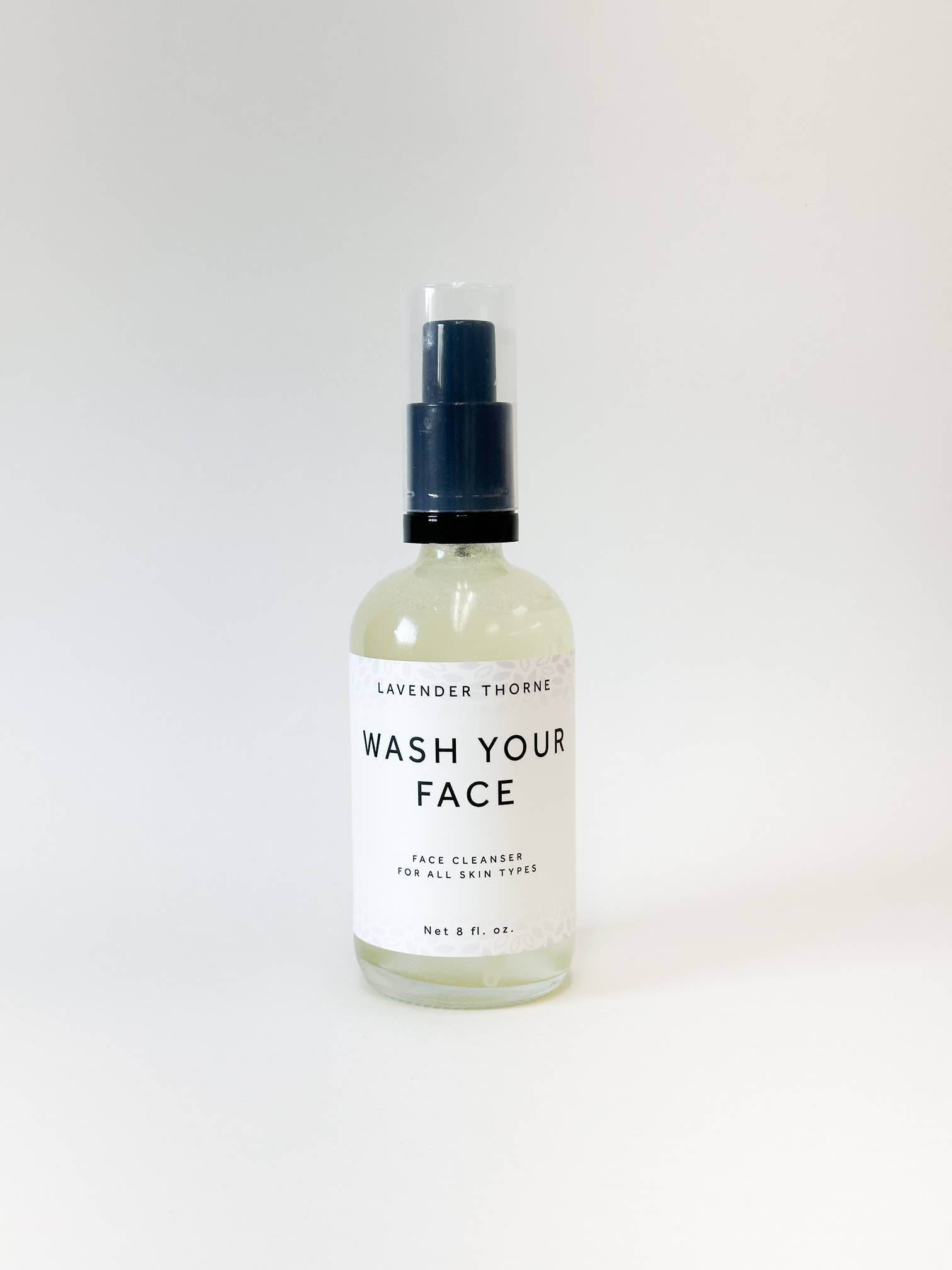 Bottle of Wash Your Face gentle facial cleanser, unclogs pores and clears acne for all skin types